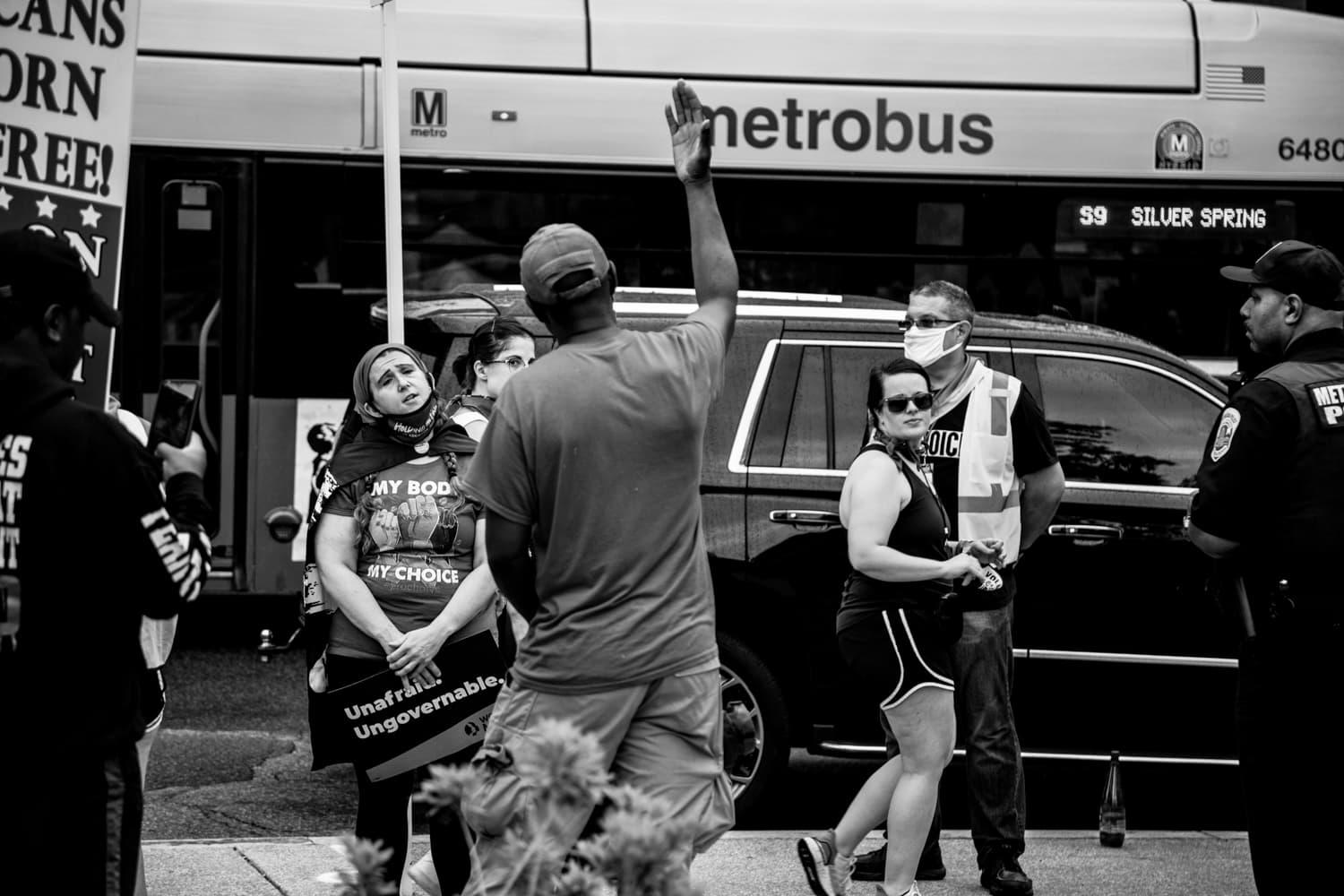 A protester debates a pro-life agitator outside the perimeter of the march. Agitators stood next to the porta-potties (of course) and shouted their ridiculous rhetoric at every woman that walked by. The police stood next to them to ensure they didn't physically approach anyone and a de-escalator from the Women's March organization stood between the protestors and agitators to ask them not to engage. Powerful organizing. 